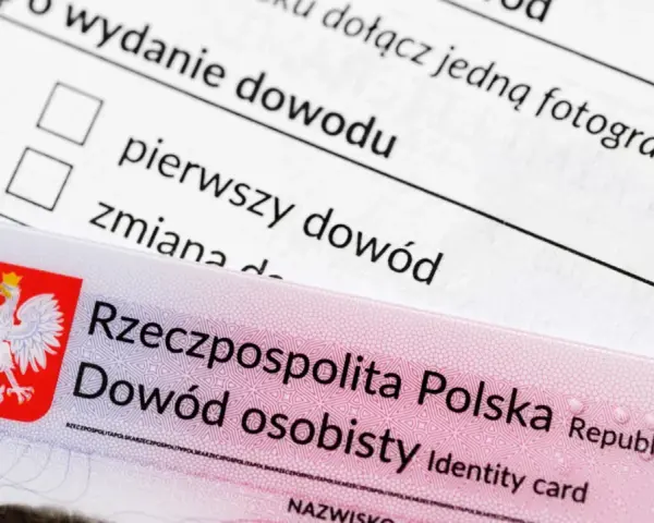 Nowy dowód osobisty leży na formularzu wniosku. Widoczny jest orzeł w koronie i napis "Rzeczpospolita Polska".