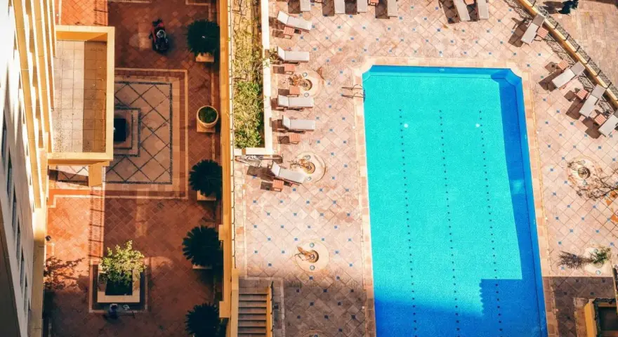 Widok z góry na basen i dziedziniec hotelowy. Idealne miejsce na wakacje all inclusive soft.